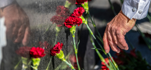 Attendees lay down carnations in solemn tribute during the Babi Yar Commemoration.